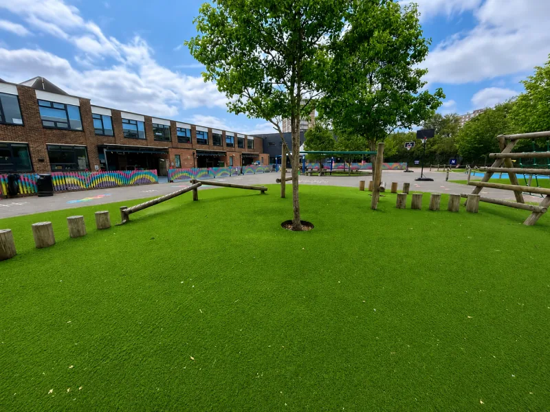 School playground with artificial lawn and play areas maintained by Lea Valley Garden Services at Ark John Keats Academy, Enfield